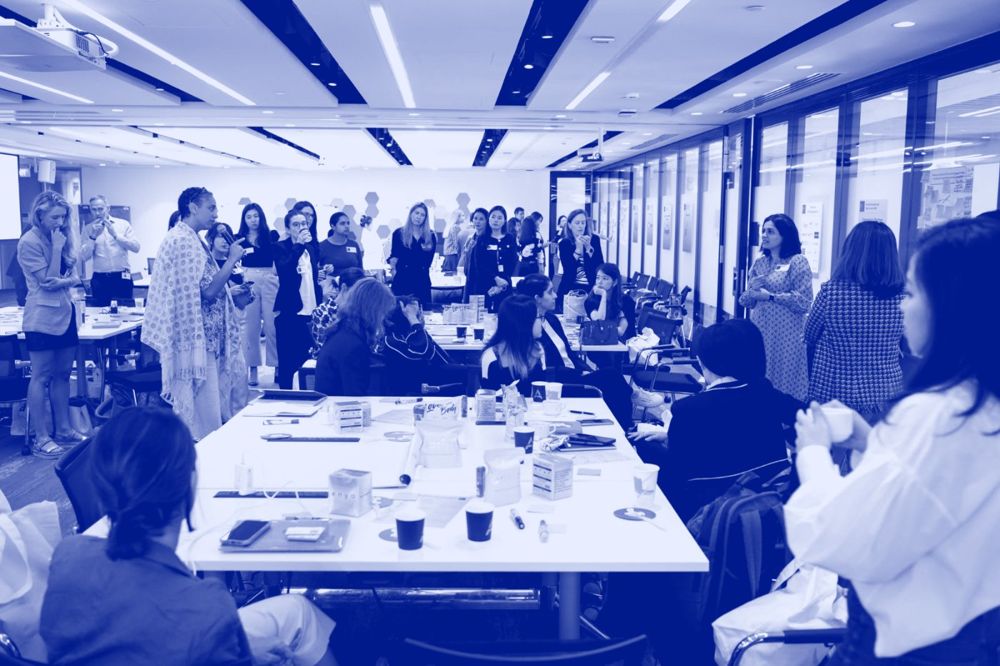 A full room of delegates in discussion